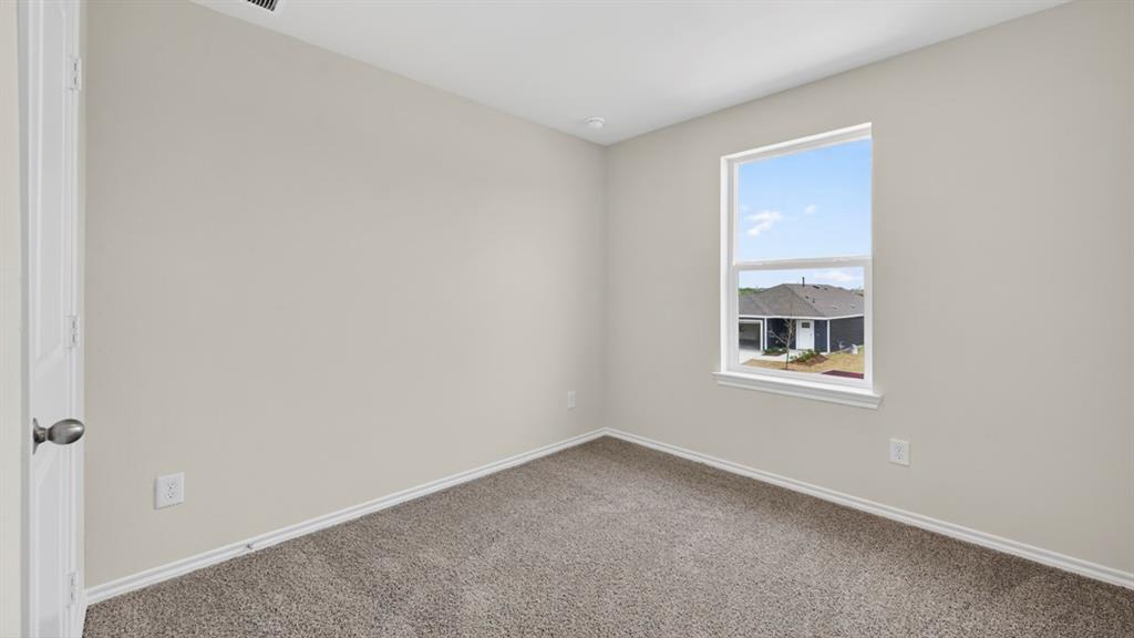 3534 Spring Time Street Forney, TX 75126 - Photo 20 of 24 Interior room with light gray walls, white trim, and gray carpeted flooring