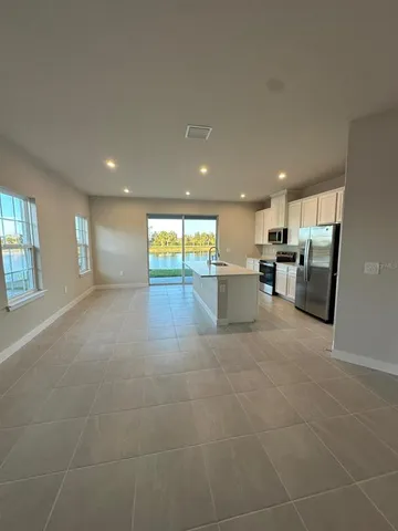 an empty room with windows and closet
