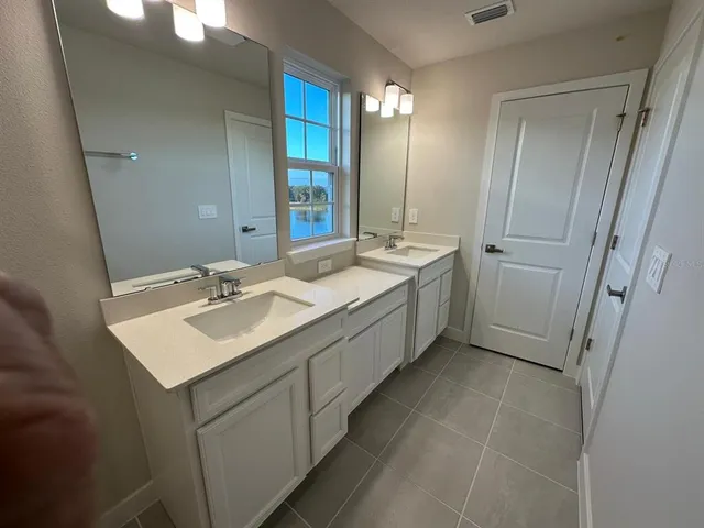 a room with sink and mirror