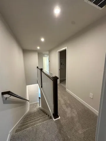 a large white kitchen with kitchen island a sink a stove and a refrigerator