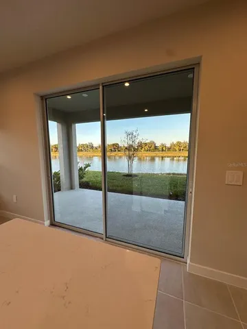 a white toilet sitting next to a white sink and vanity
