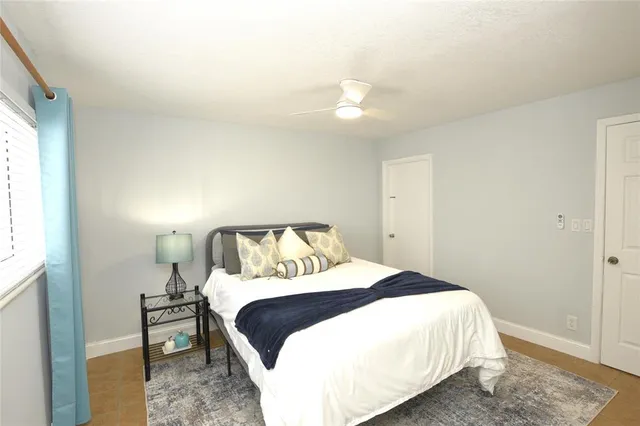 a bedroom with a bed and a window