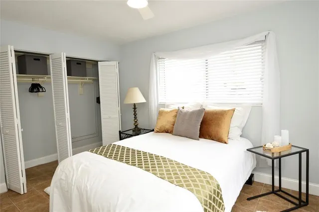 a bedroom with a large bed and a chandelier