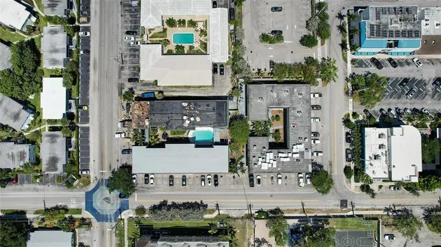 an aerial view of residential houses with outdoor space and parking