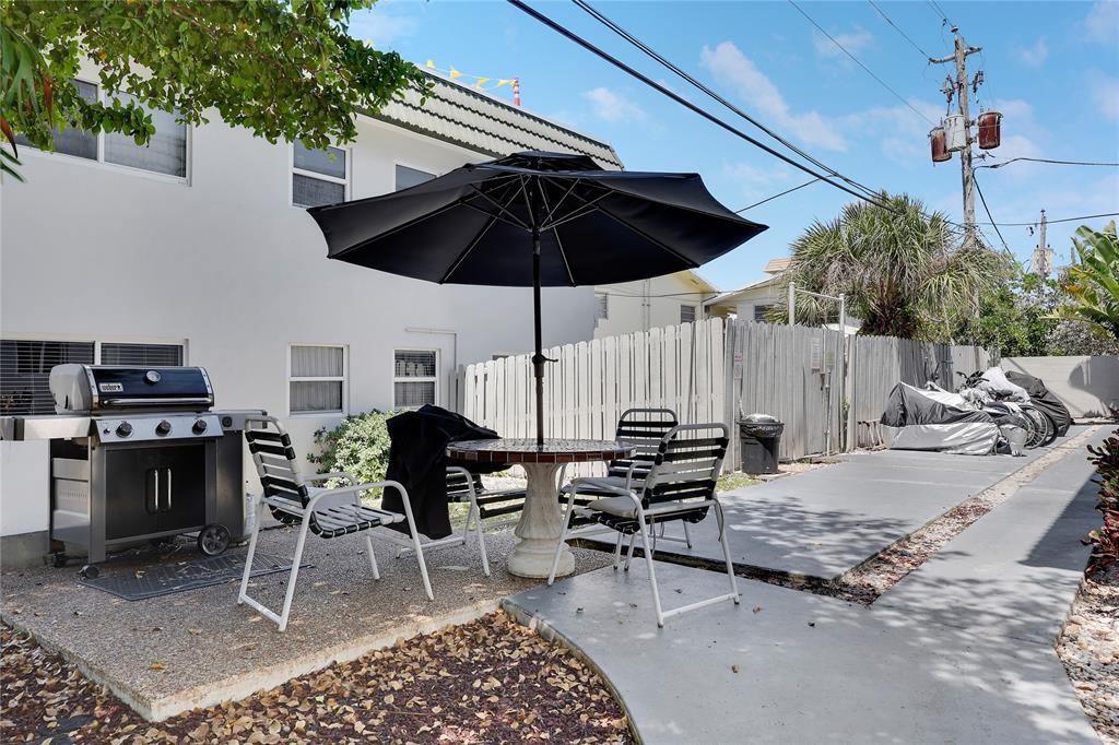1010 Southeast 15th Street, Unit 112 Fort Lauderdale, FL 33316 - Photo 20 of 21 a view of a dinning table and chairs in patio