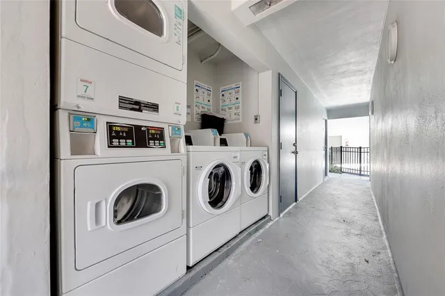 a view of washer and dryer with kitchen in the background