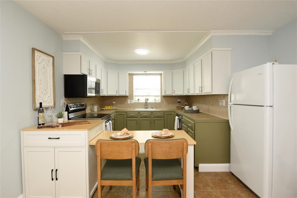 1010 Southeast 15th Street, Unit 112 Fort Lauderdale, FL 33316 - Photo 3 of 21 a kitchen with a refrigerator a stove a microwave and cabinets