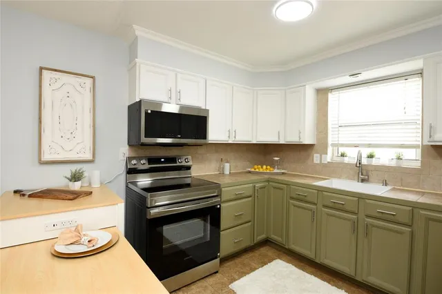 a kitchen with a sink stove and microwave
