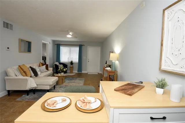 a living room with furniture and a wooden floor