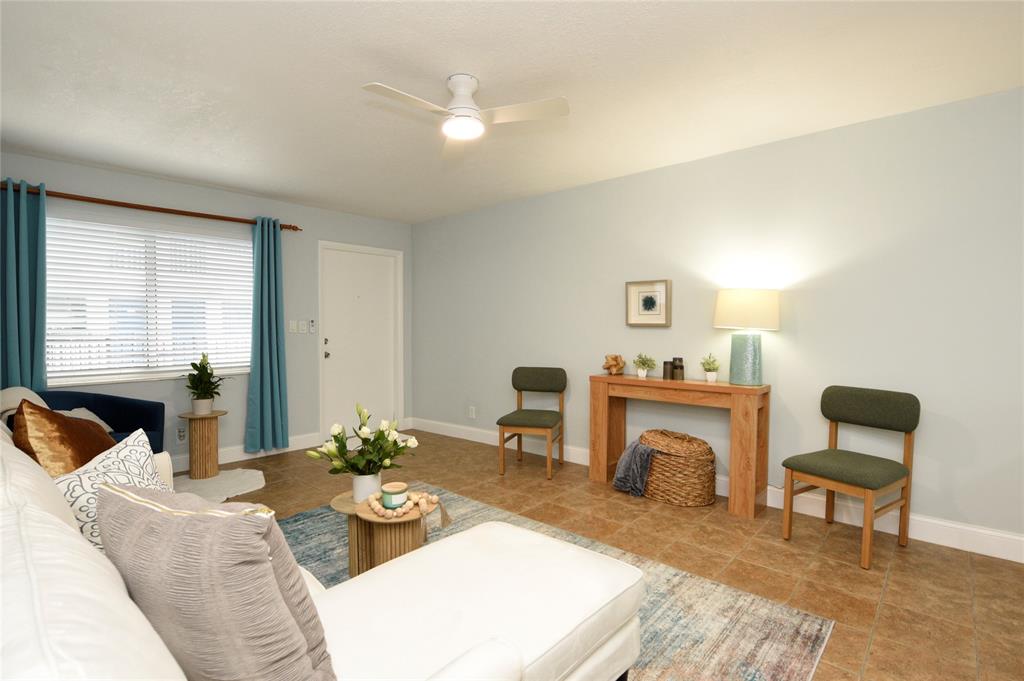 1010 Southeast 15th Street, Unit 112 Fort Lauderdale, FL 33316 - Photo 7 of 21 a living room with furniture a fireplace and a table