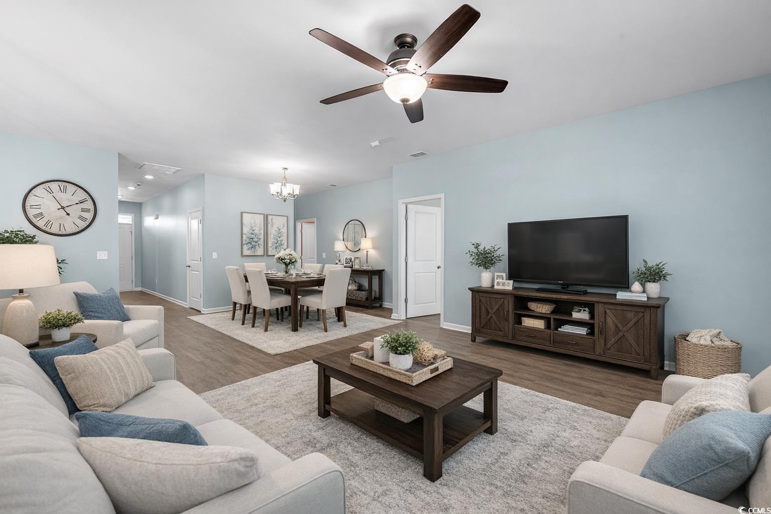292 Carmello Circle Conway, SC 29526 - Photo 16 of 33 Spare room with a chandelier, dark wood-type flooring, and a ceiling fan