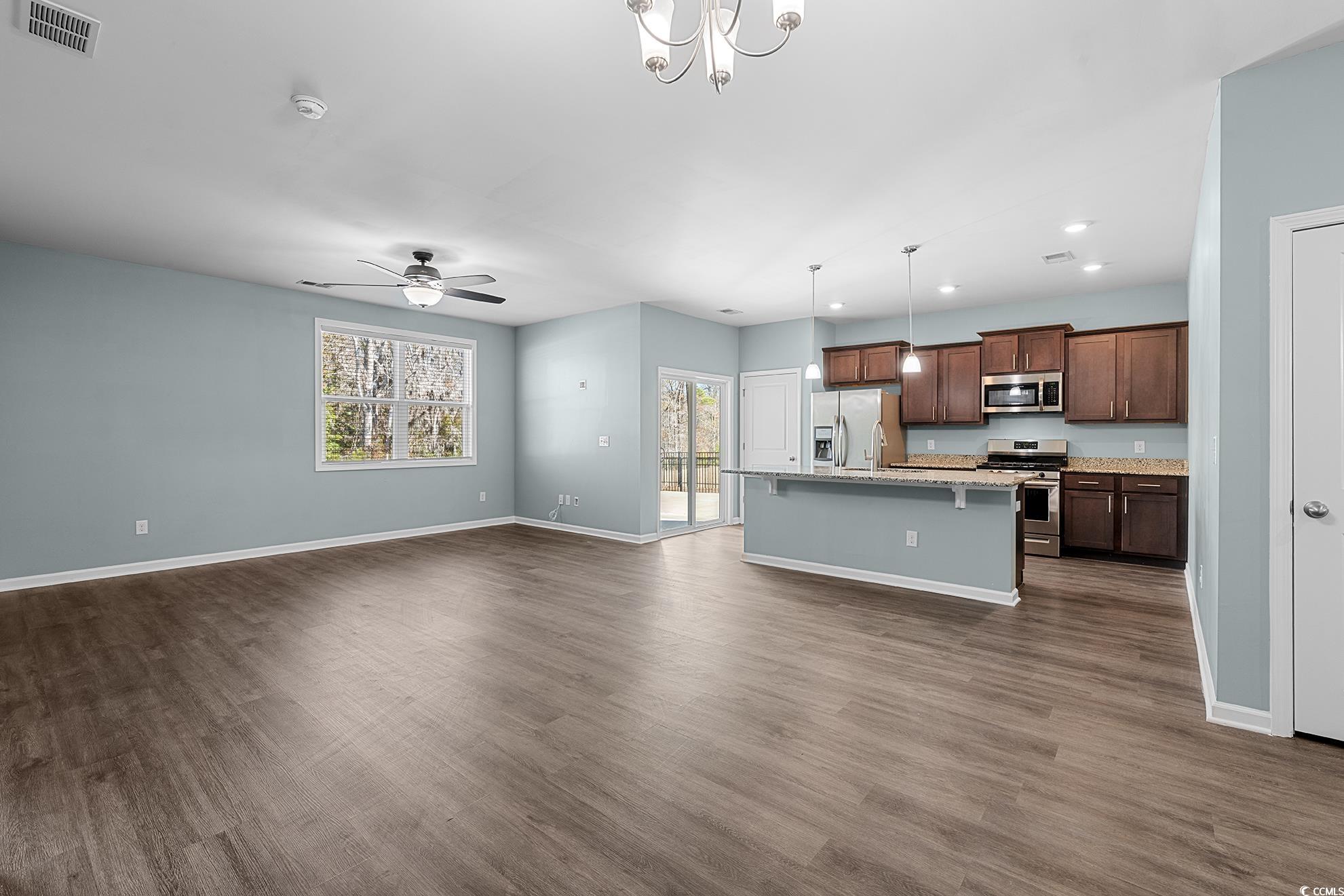 292 Carmello Circle Conway, SC 29526 - Photo 32 of 33 Kitchen with open floor plan, decorative light fixtures, an island with sink, appliances with stainless steel finishes, and a chandelier