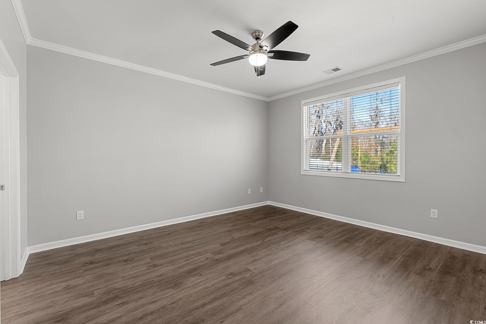 292 Carmello Circle Conway, SC 29526 - Photo 17 of 33 Primary Bedroom featuring ornamental molding, dark wood-style floors, and a ceiling fan