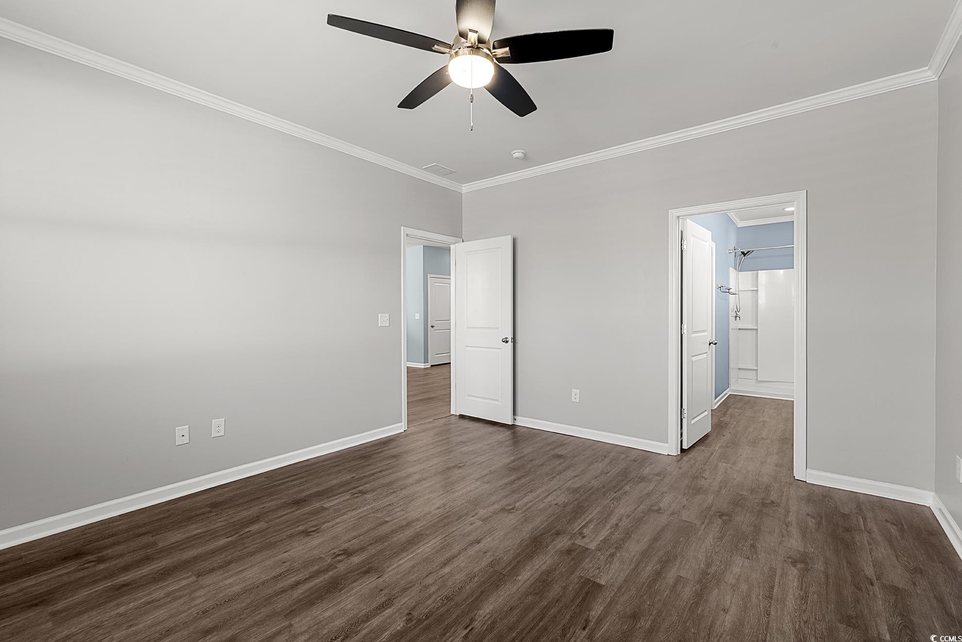 292 Carmello Circle Conway, SC 29526 - Photo 19 of 33 Unfurnished bedroom with crown molding, dark wood-style floors, a ceiling fan, and ensuite bathroom