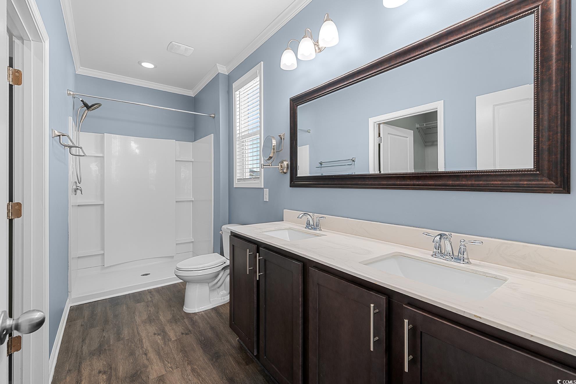 292 Carmello Circle Conway, SC 29526 - Photo 20 of 33 Full bathroom with a stall shower, double vanity, dark wood-style floors, crown molding, and recessed lighting