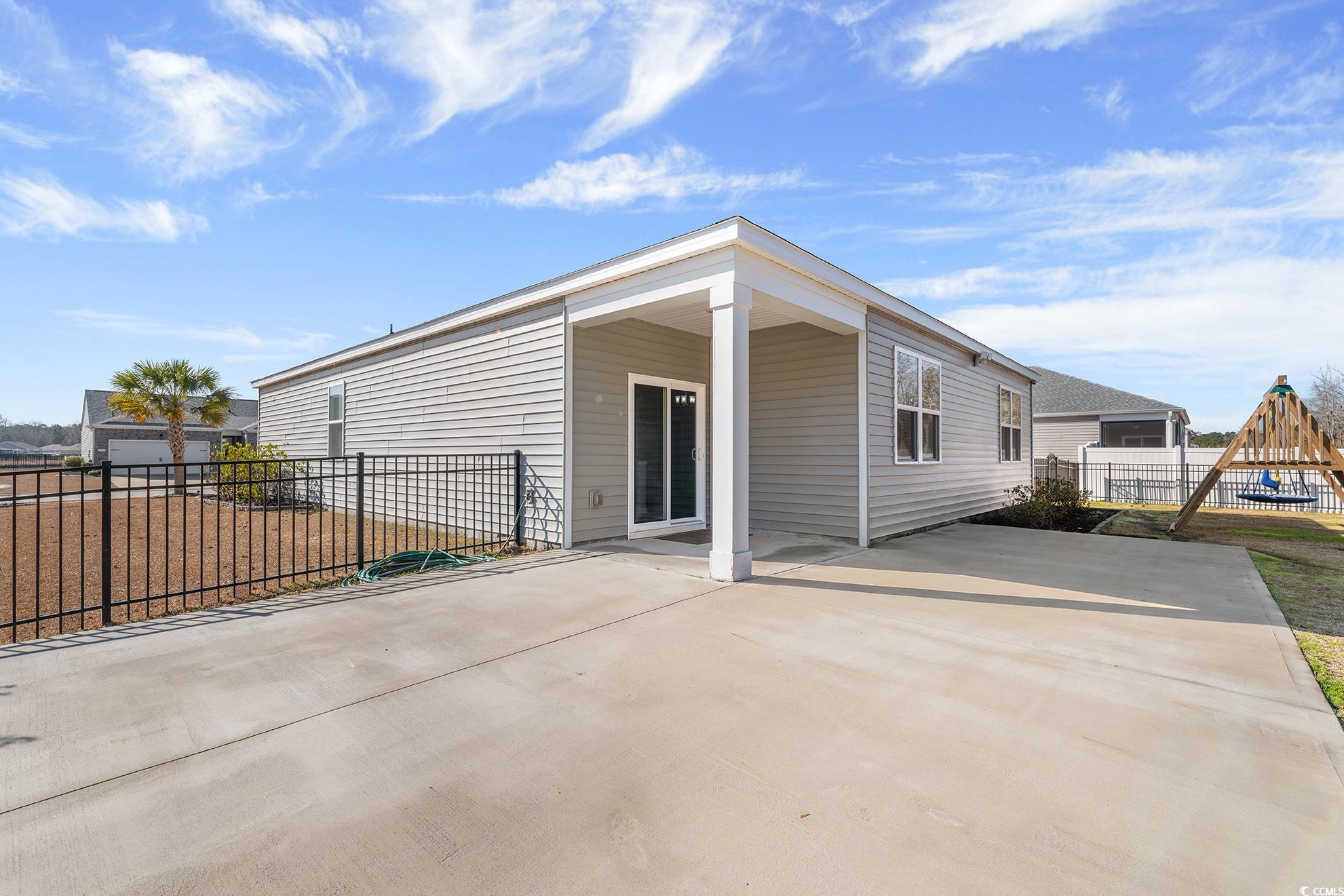 292 Carmello Circle Conway, SC 29526 - Photo 25 of 33 Rear view of house featuring a patio and a playground