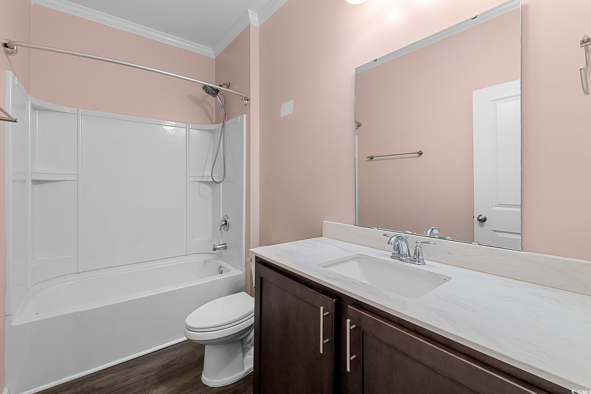 292 Carmello Circle Conway, SC 29526 - Photo 9 of 33 Bathroom with bathtub / shower combination, crown molding, vanity, and dark wood-type flooring
