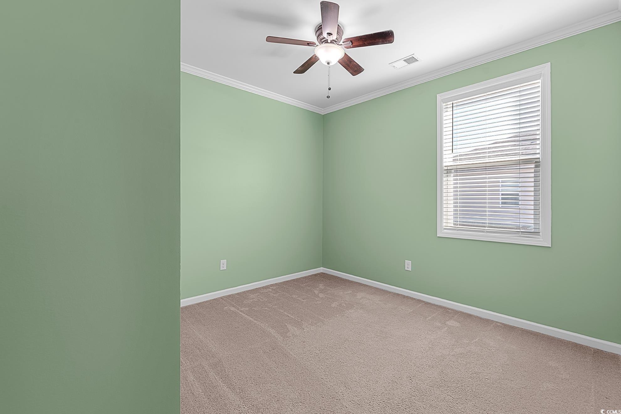 292 Carmello Circle Conway, SC 29526 - Photo 10 of 33 Unfurnished room featuring carpet, crown molding, and ceiling fan
