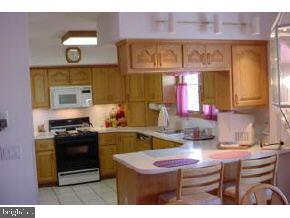 114 Clifton Road Barnegat, NJ 08005 - Photo 3 of 6 a kitchen with a stove a sink and a cabinets