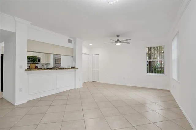 a view of a kitchen with an empty space and a window