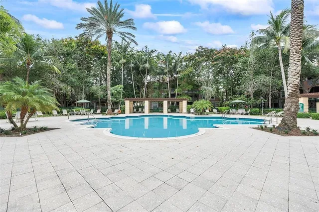 a backyard of a house with fountain and outdoor seating