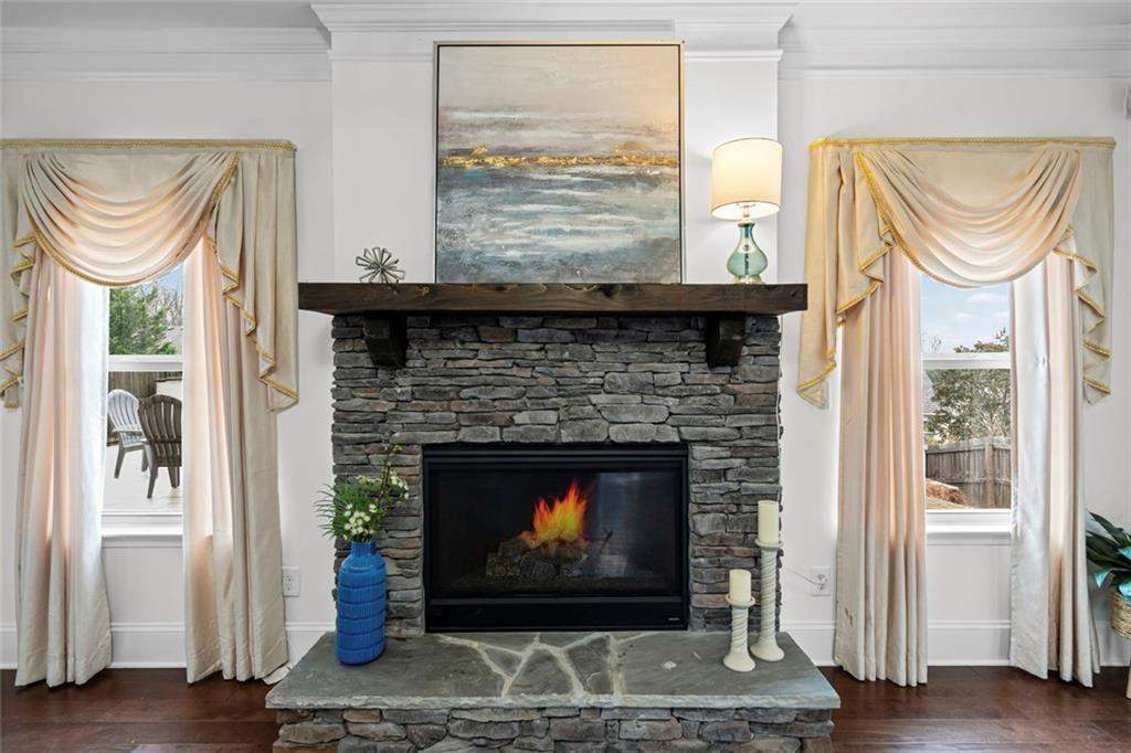 3915 Estates Path Cumming, GA 30040 - Photo 14 of 50 a living room with a fireplace and a window