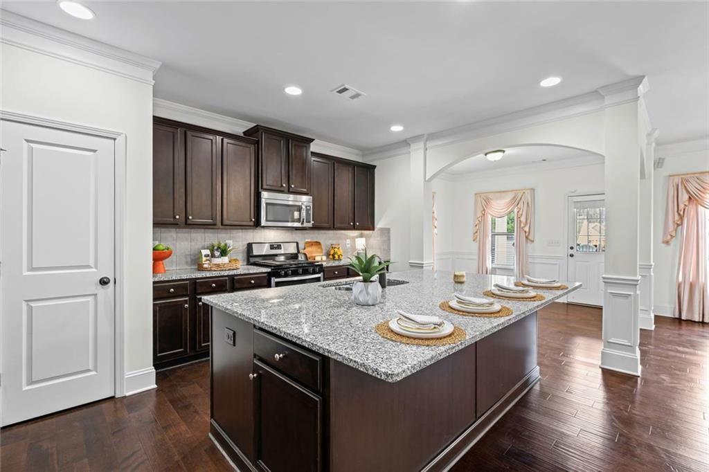 3915 Estates Path Cumming, GA 30040 - Photo 18 of 50 a kitchen with sink stove and cabinets