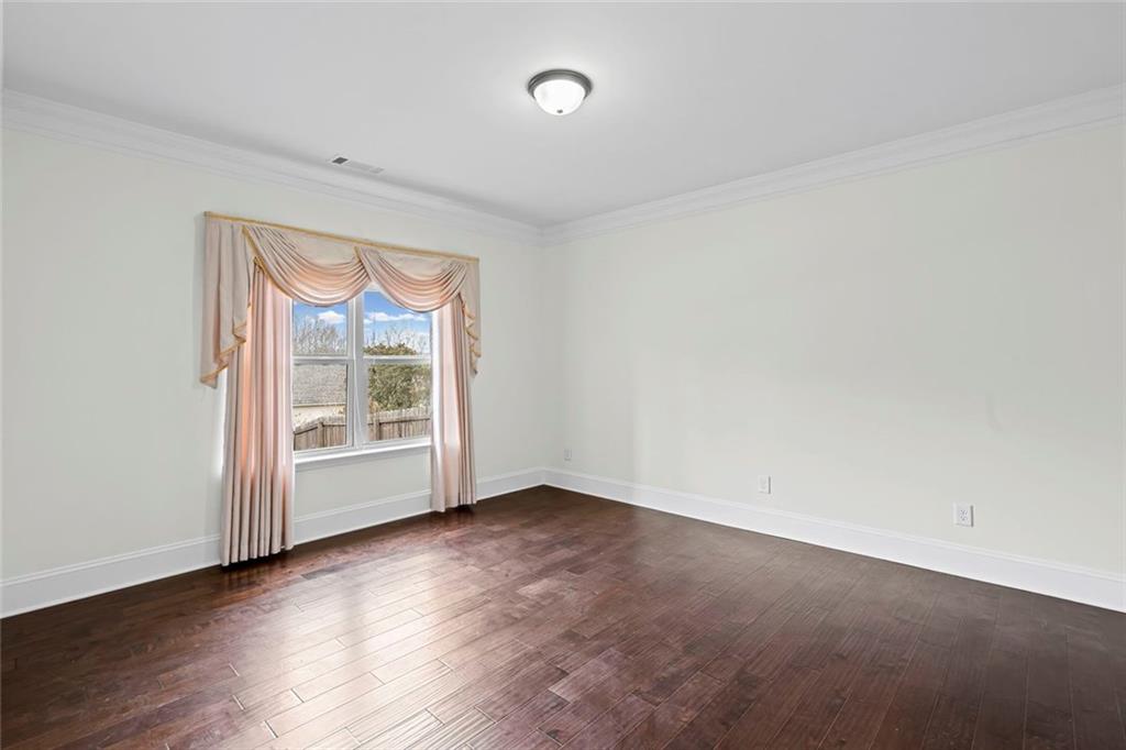 3915 Estates Path Cumming, GA 30040 - Photo 22 of 50 an empty room with wooden floor and windows