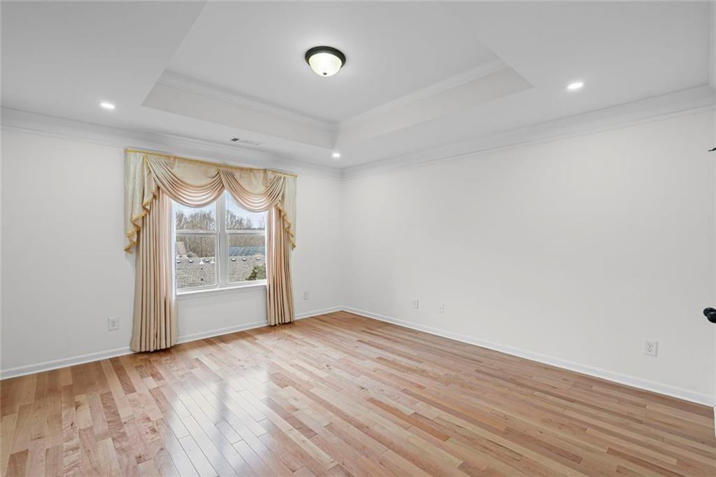 3915 Estates Path Cumming, GA 30040 - Photo 28 of 50 an empty room with wooden floor and a window