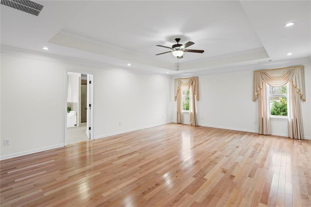 3915 Estates Path Cumming, GA 30040 - Photo 29 of 50 a view of an empty room with a window and wooden floor