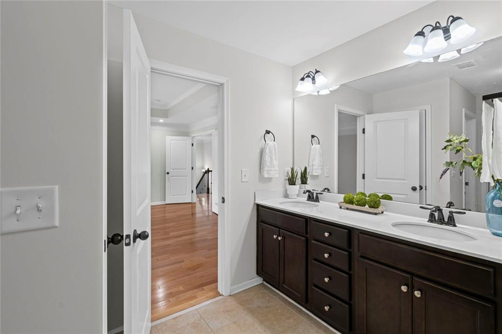 3915 Estates Path Cumming, GA 30040 - Photo 34 of 50 a bathroom with a double vanity sink and a mirror
