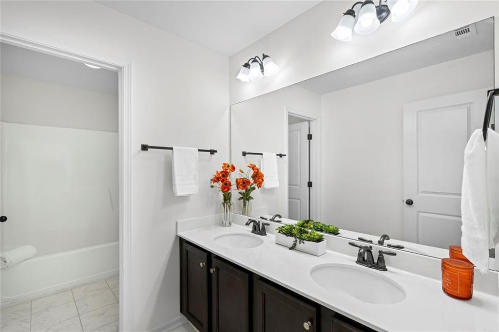 3915 Estates Path Cumming, GA 30040 - Photo 40 of 50 a bathroom with a sink and a mirror