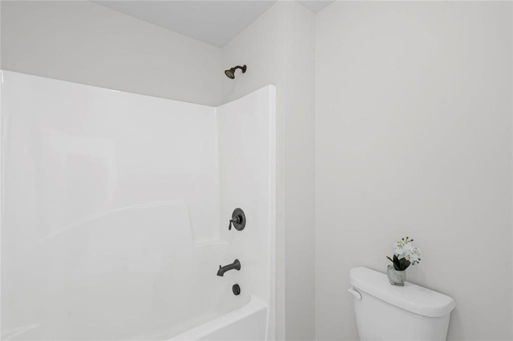3915 Estates Path Cumming, GA 30040 - Photo 41 of 50 a white bath tub sitting next to a white toilet
