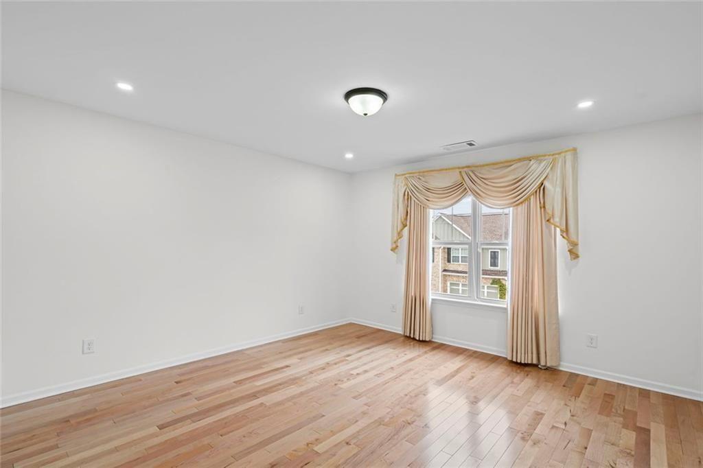 3915 Estates Path Cumming, GA 30040 - Photo 42 of 50 an empty room with wooden floor and windows