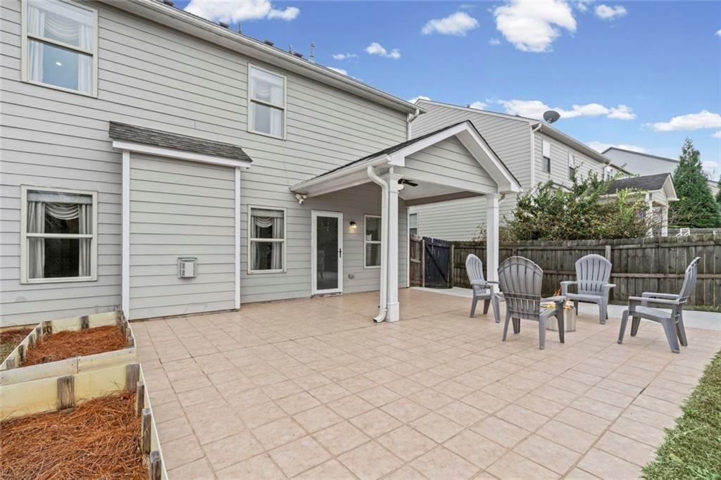 3915 Estates Path Cumming, GA 30040 - Photo 48 of 50 a front view of house with yard outdoor seating and barbeque oven