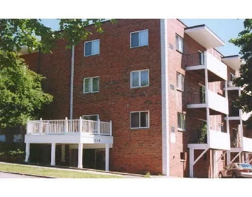a front view of a building with a garden