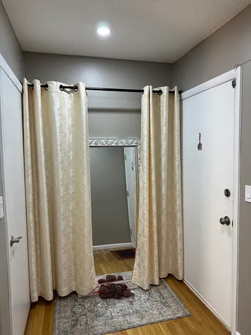 a bedroom with a bed and wooden floor