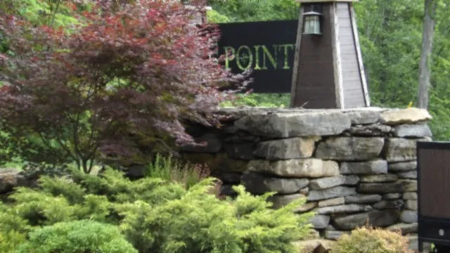 a close up of a glass door with a white building