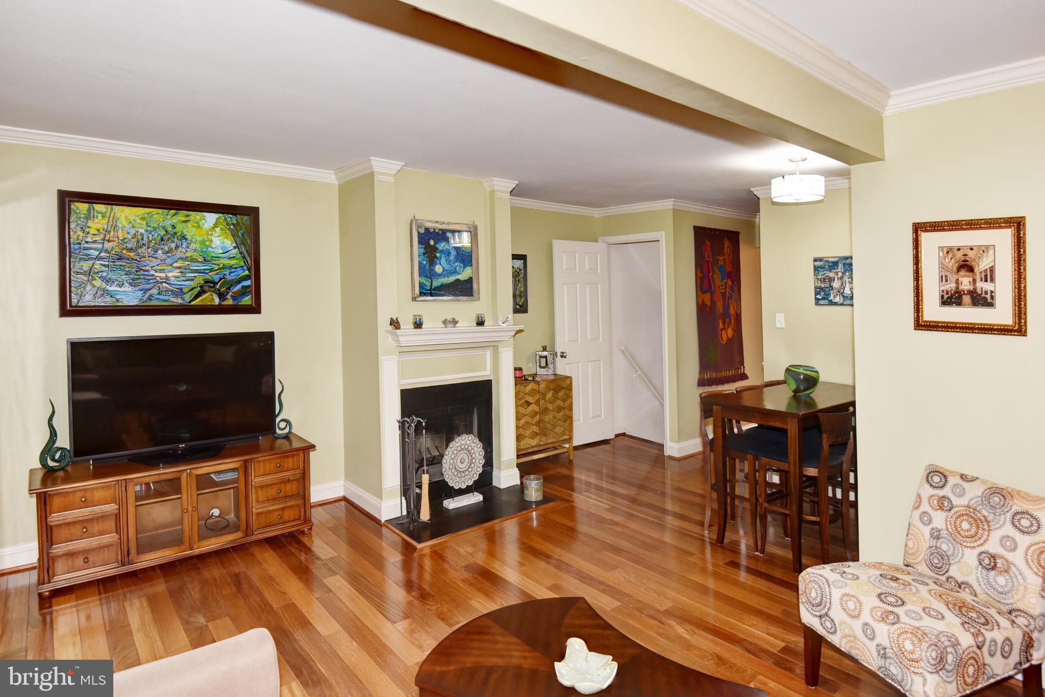 2423 Alsop Court Reston, VA 20191 - Photo 8 of 44 a living room with furniture a flat screen tv and a fireplace