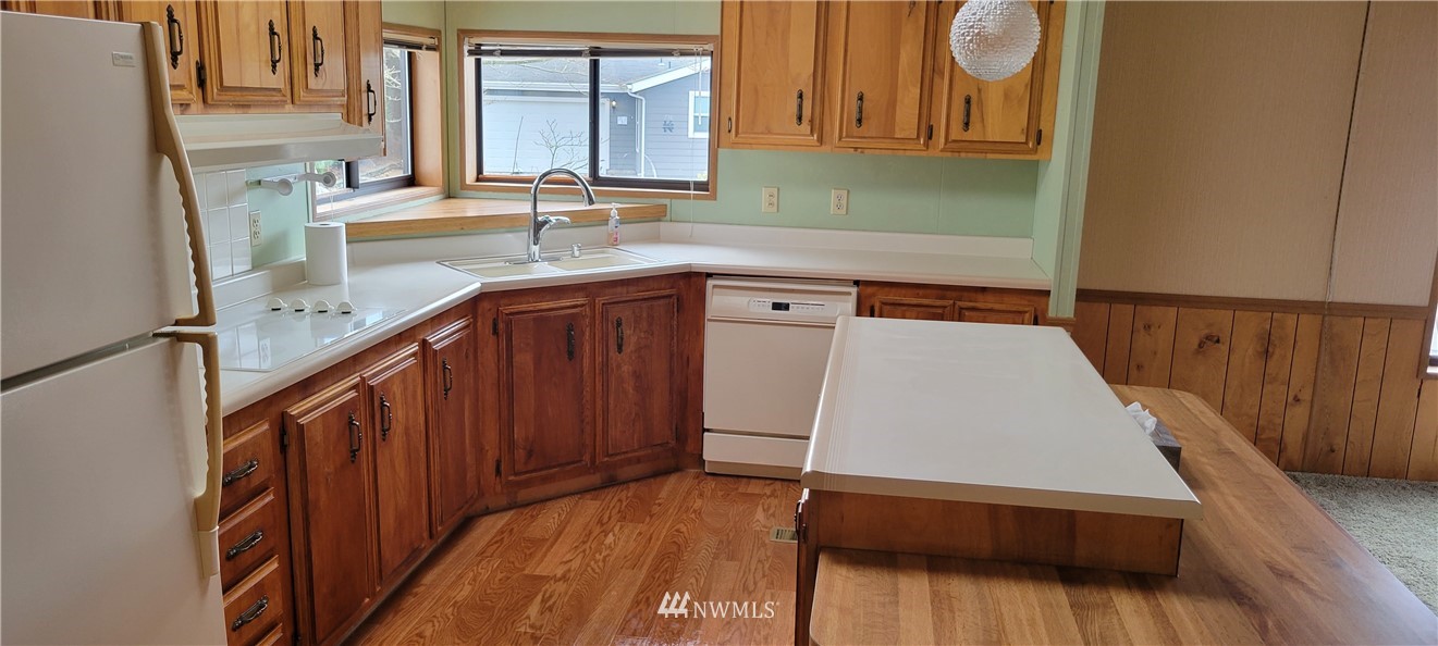 729 236th Place Southwest Bothell, WA 98021 - Photo 20 of 40 a kitchen with wooden cabinets a sink and a window