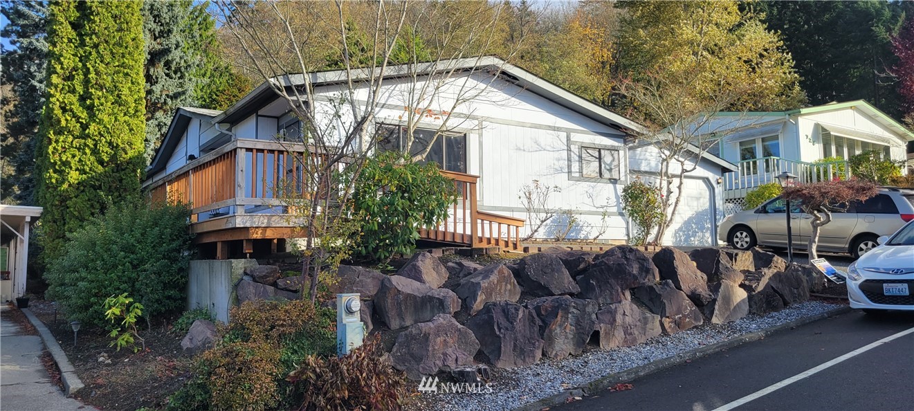 729 236th Place Southwest Bothell, WA 98021 - Photo 4 of 40 a view of a house with a cars park side of a road