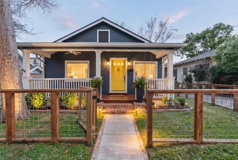 a view of a house with wooden floor next to a yard