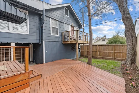 a view of a backyard with a large tree