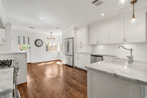 a kitchen with refrigerator and cabinets