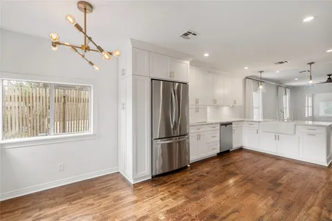 a kitchen with stainless steel appliances granite countertop a refrigerator a sink and a stove