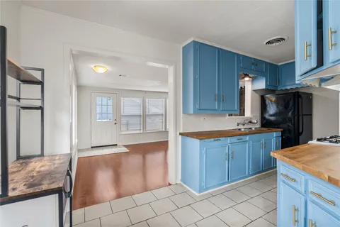 a kitchen with granite countertop a sink and cabinets
