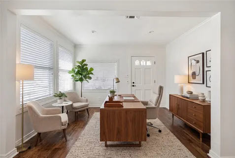 a room with furniture a potted plant and a window