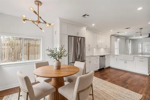 a kitchen with a table and chairs in it