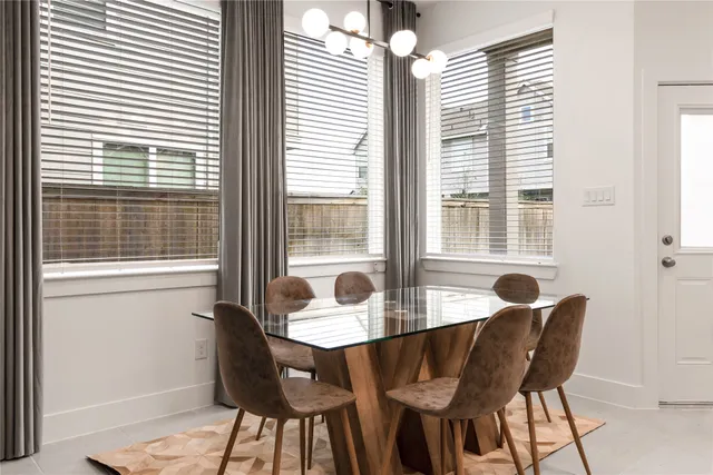 a dining room with furniture and windows