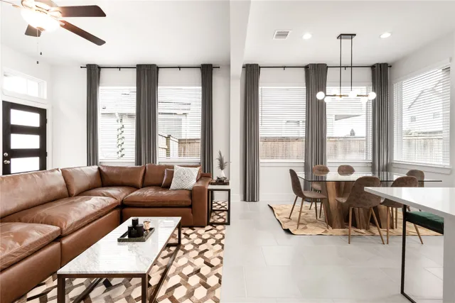 a living room with furniture wooden floor and a large window
